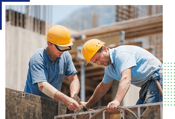 Two men in hard hats working on a construction site.