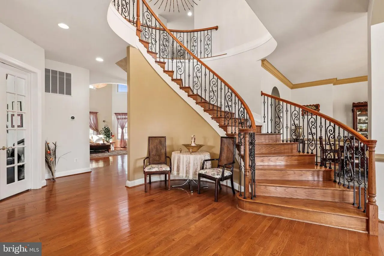 A large room with wooden floors and stairs.