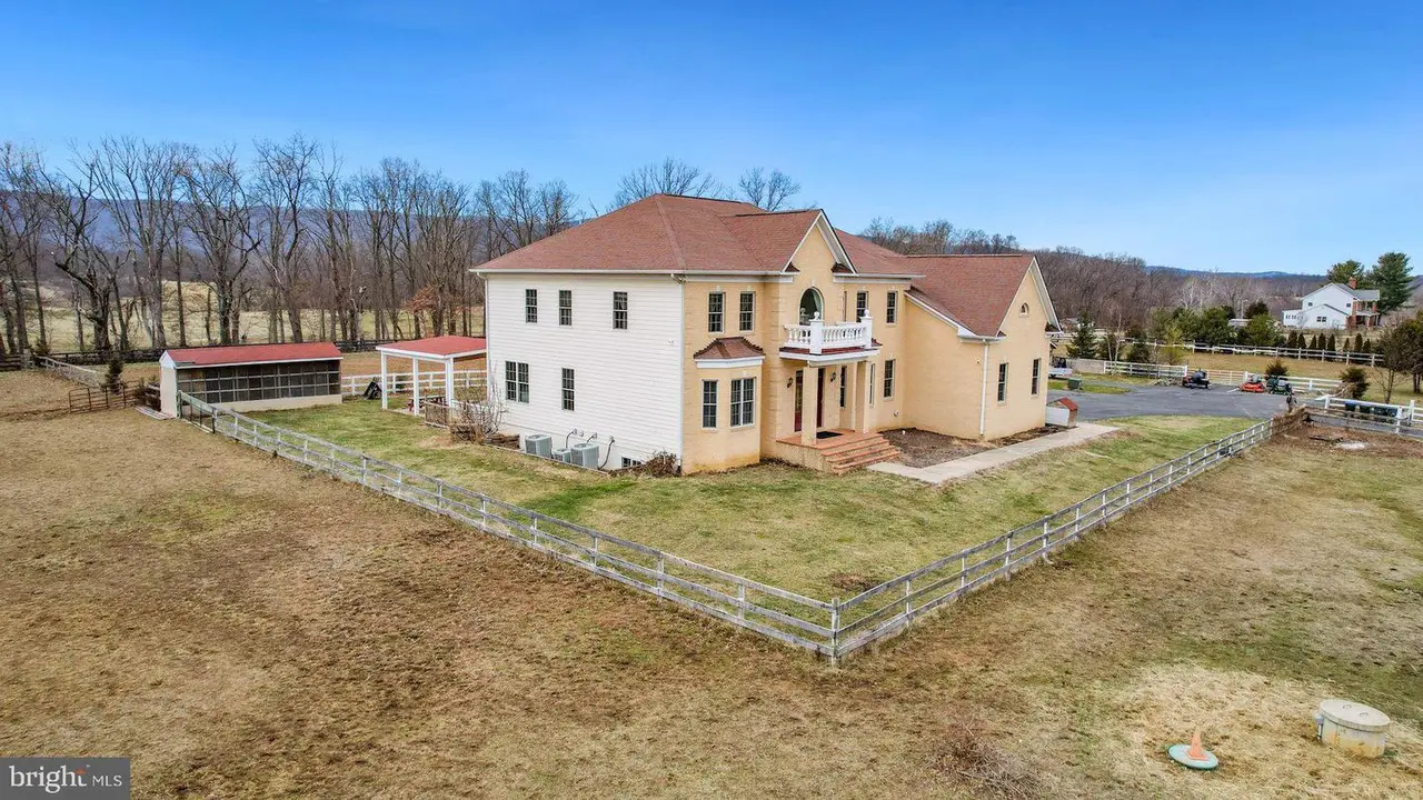 A large house with a fenced in yard.